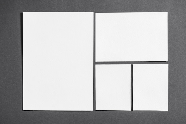 Set of vivid blank white papers on grey background