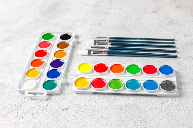 Set of watercolor paints and paintbrushes for painting.