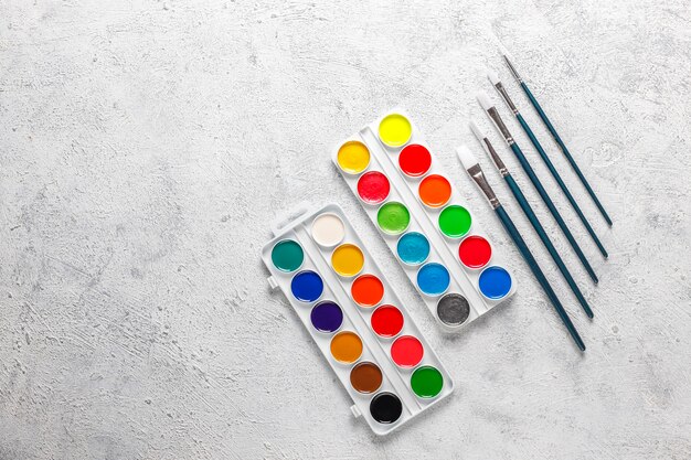 Set of watercolor paints and paintbrushes for painting.