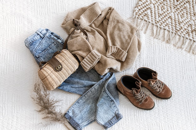 Set with fashionable women's clothing jeans and a sweater .