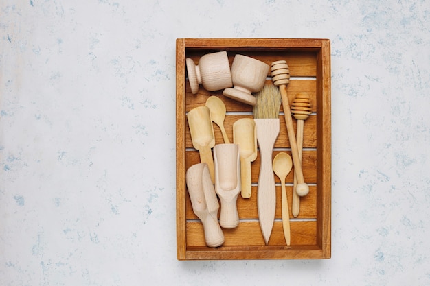 Set of wooden kitchen utensils on concrete surface