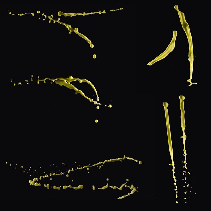 Free Photo set of yellow paint splashing on black backdrop