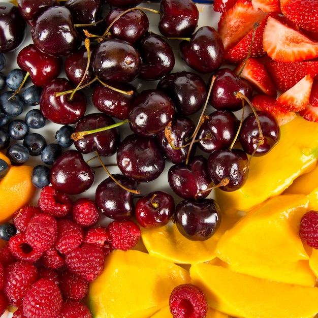 several colorful fruits over white background