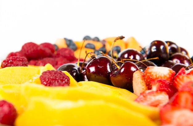 several colorful fruits over white background