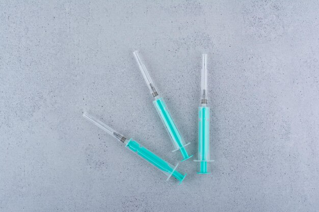 Several empty syringes on marble b