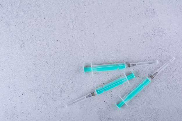 Several empty syringes on marble background. High quality photo