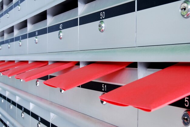 Several letterboxes with red envelopes