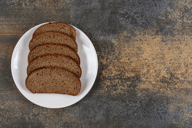 Free photo several slices of rye bread on white plate