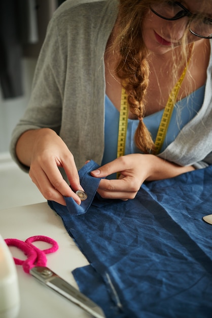 Sewing buttons on cloth