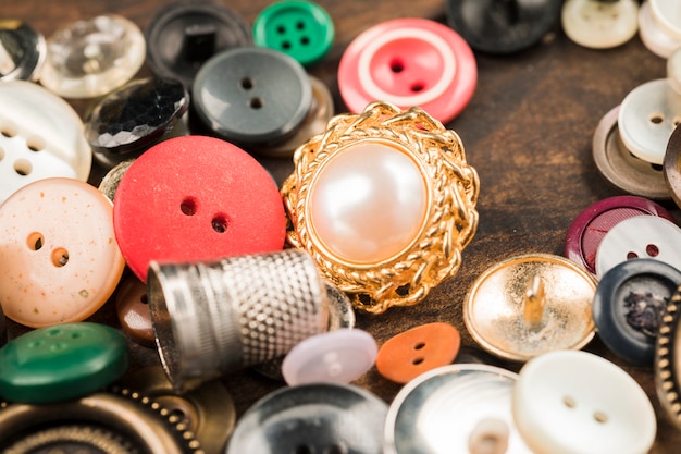 Sewing buttons with thimble