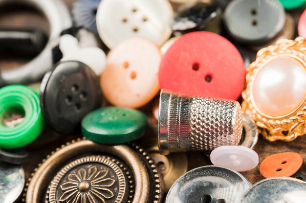 Sewing buttons with thimble