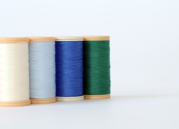 Sewing. Colorful threads on a white background