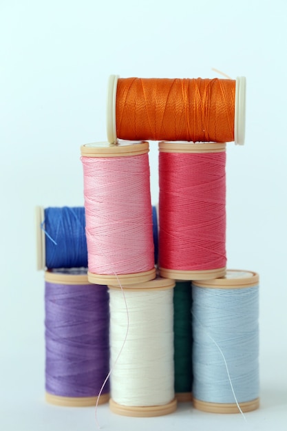 Free photo sewing. colorful threads on a white background