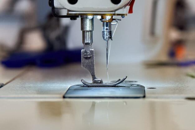 Sewing machine and white thread close up