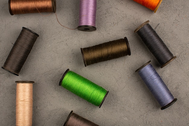 Sewing threads colorful on a grey desk