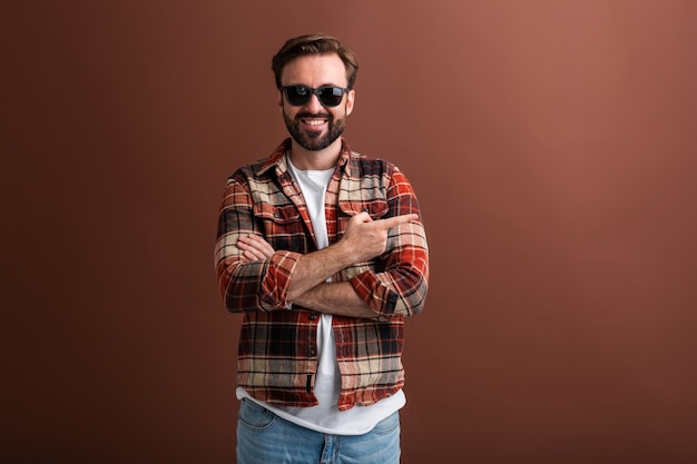 Sexy attractive male, confident hipster handsome stylish bearded man on brown