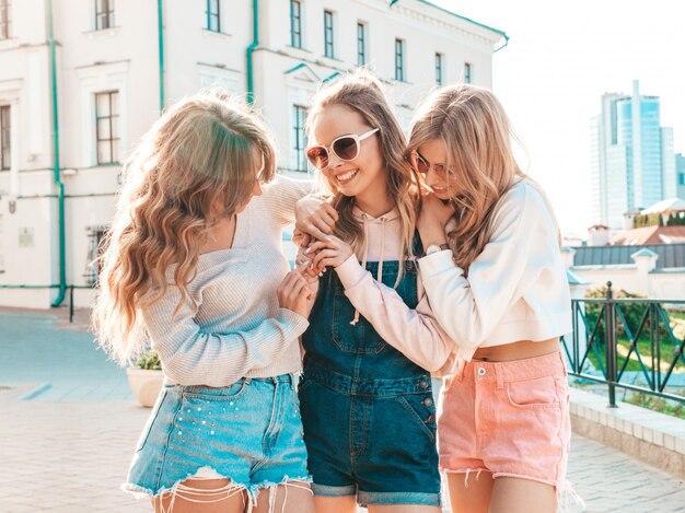  Sexy carefree women posing on the street background Hugging at sunset