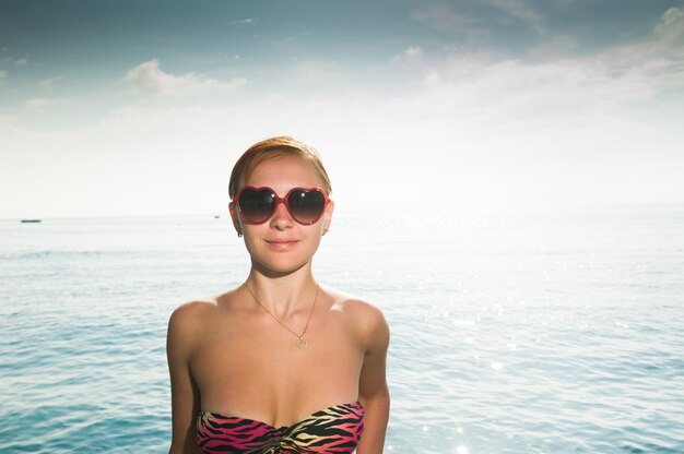 Sexy red girl wearing bikini at the beach