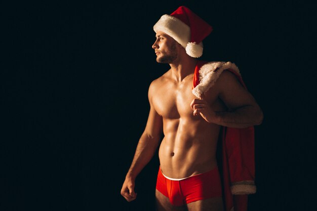 Sexy santa man naked on black background