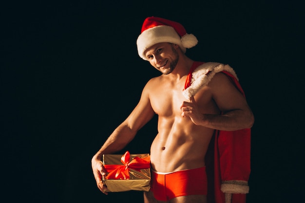 Sexy santa man naked on black background