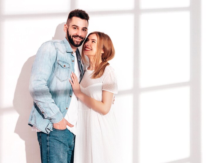 Free Photo sexy smiling beautiful woman and her handsome boyfriend happy cheerful family having tender moments near white wall in studiopure cheerful models huggingembracing each other