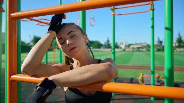 Sexy sportswoman posing at sports ground