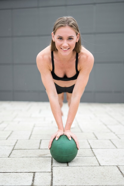 Sexy woman doing push up on a ball