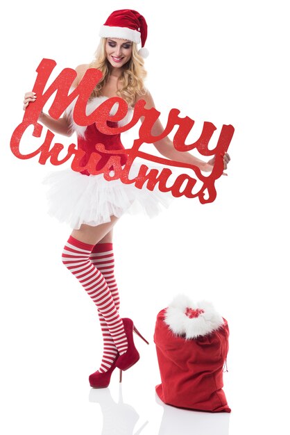 Free photo sexy woman in santa costume posing on white wall