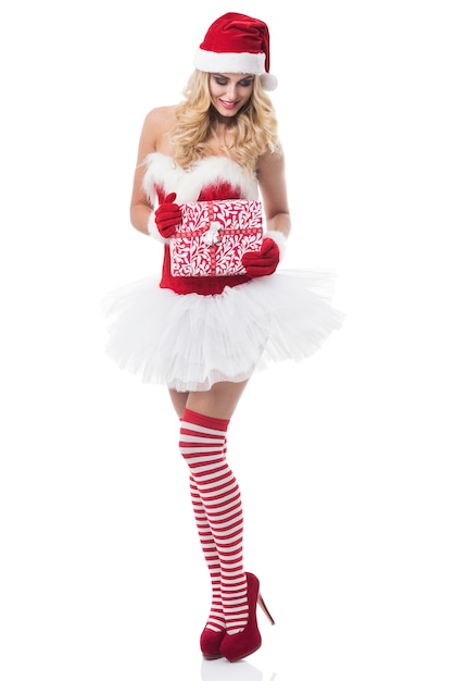 Free photo sexy woman in santa costume posing on white wall