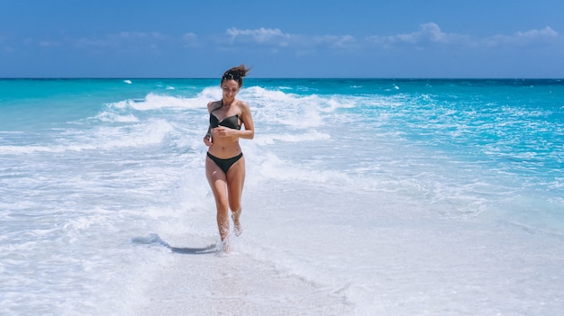Sexy woman in swim wear standing in the ocean