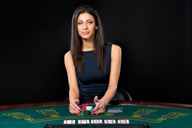 sexy woman with poker cards and chips. Female player in a beautiful black dress