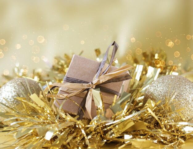 Shabby chic gift box nestled in gold Christmas garland