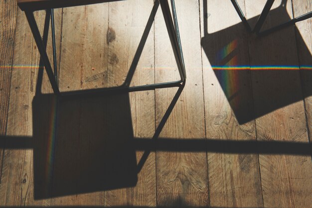 Free photo shadow of chair and wooden plank