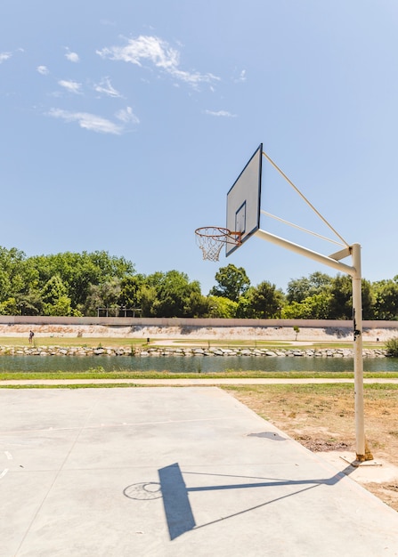 Shadow of an empty basketball hoop at outdoors court