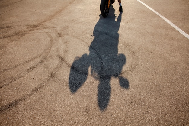 Shadow of male holding helmet