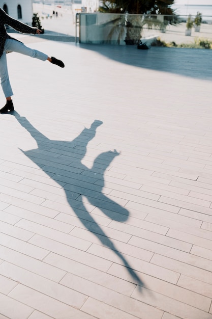 Free photo shadow of person stretching leg