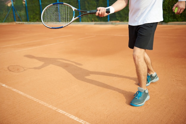 Shadow of tennis player on the court
