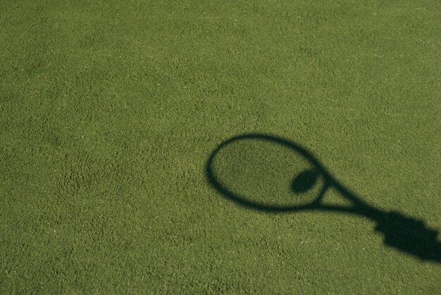 Shadow of a tennis racket with a ball 