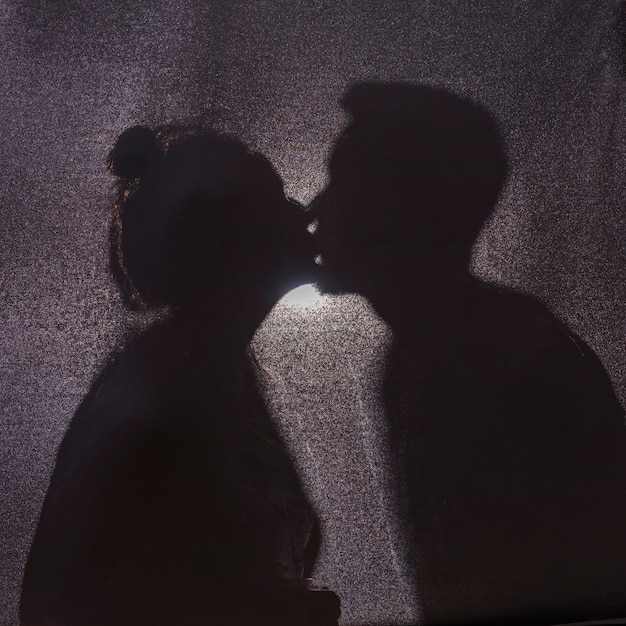 Free photo shadows of cute kissing couple