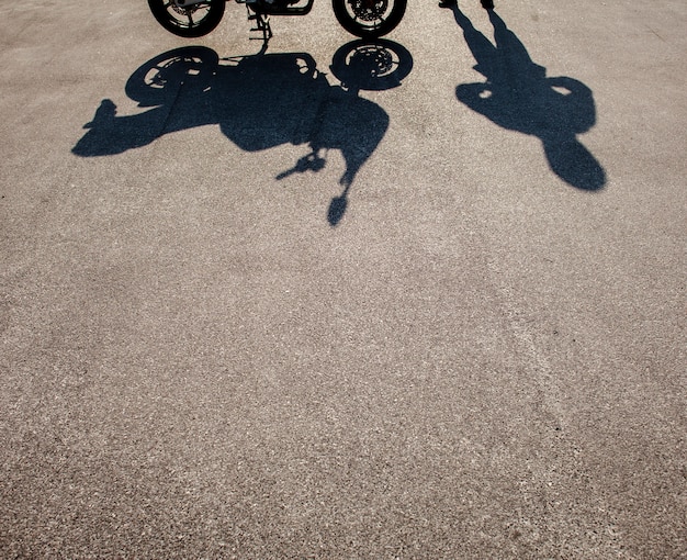 Shadows of man and motorbike