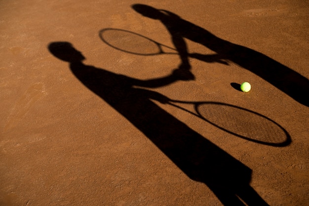 Free photo shadows of two tennis players
