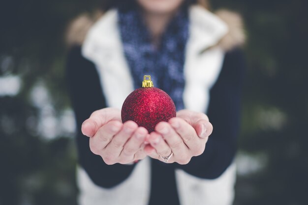 Shallow focus of person holding bauble