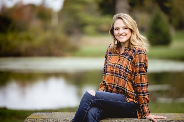 Shallow focus shot of a beautiful female sitting on the bench