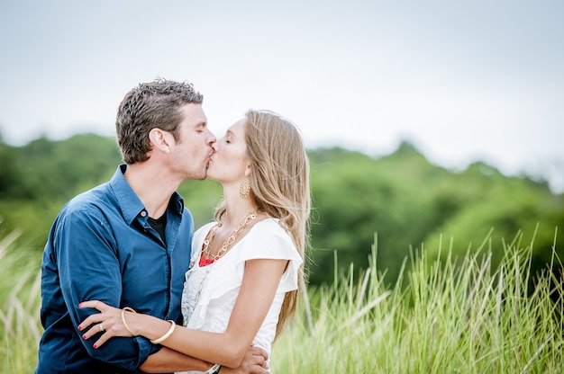 Shallow focus shot of a couple in love kissing each other