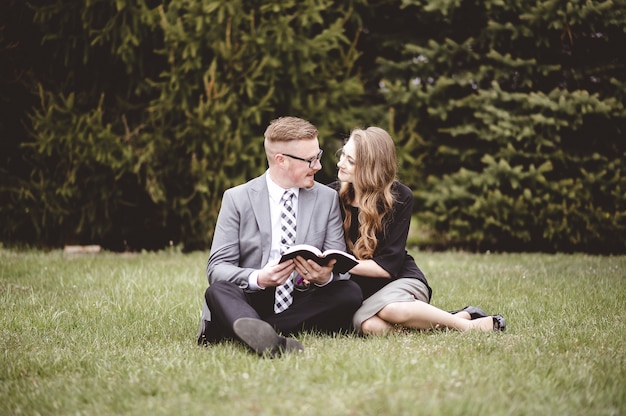 Shallow focus shot of a couple talking and enjoying each others company while sitting in a garden