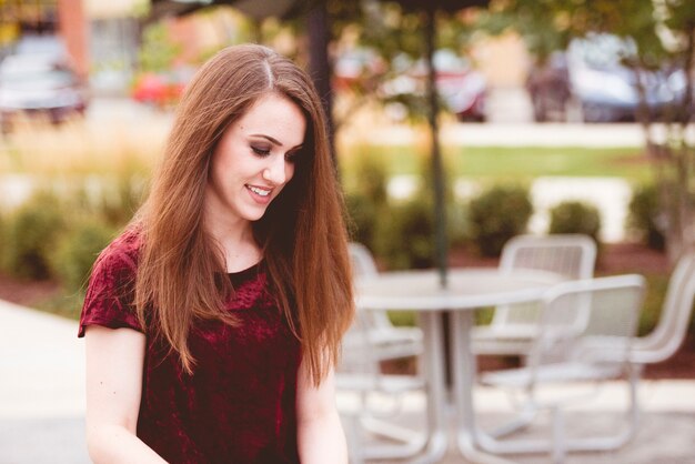 Shallow focus shot of a female looking down with a blurred background 