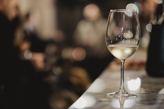 Shallow focus shot of a glass of white wine