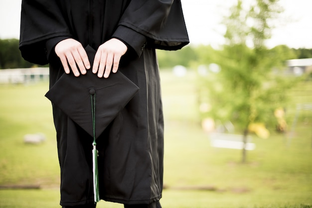 Free photo shallow focus shot of a graduate holding its hat