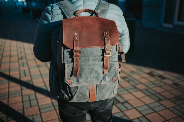 Free photo shallow focus shot of a male wearing a grey and brown rucksack