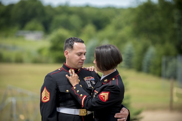 Shallow focus shot of a military couple hugging